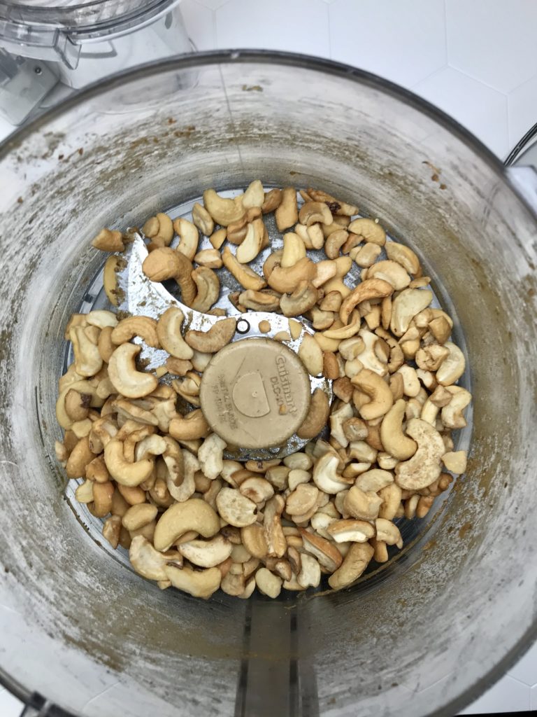 Photos shows cashews in the food processor ready to be chopped