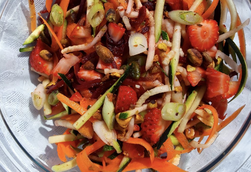 This rainbow vegetable slaw salad incorporates carrots, beets, zucchini and strawberries for a flavorful and nutrition packed salad, perfect for your next party or picnic