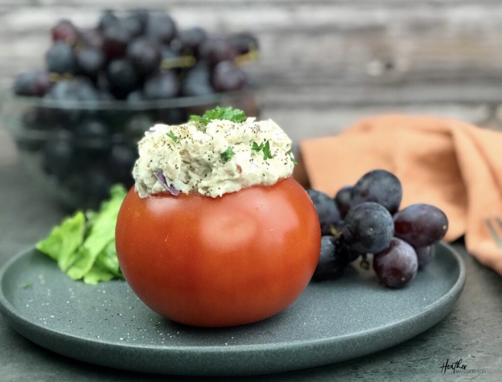 Tuna Salad stuffed into a tomato with a side of grapes