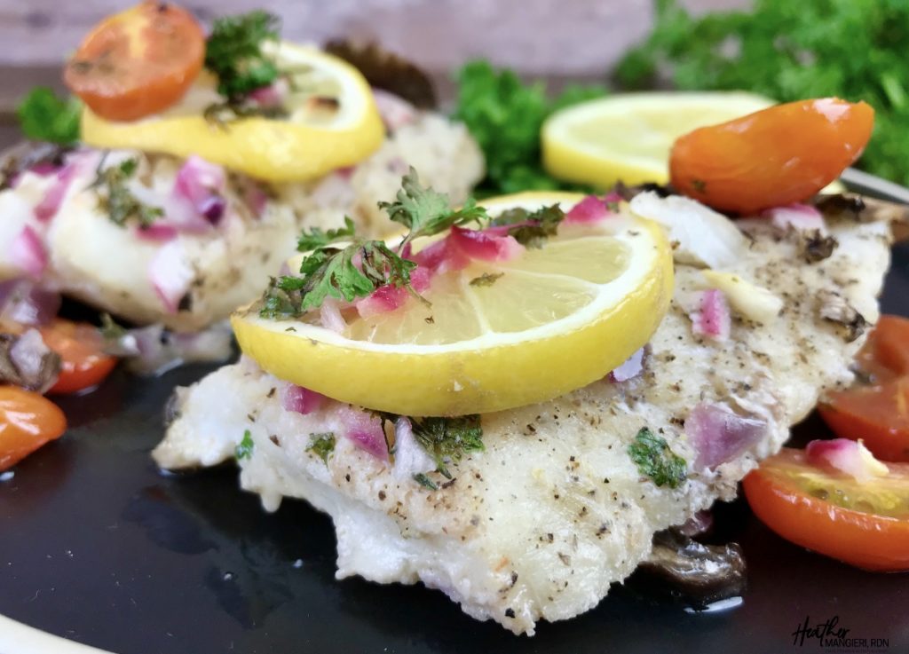 This post discusses the flavor of cod and share what it is, the calories, fat and other nutrition information of cod, and how to make a delicious lemon baked cod with mushrooms and tomatoes recipe for a quick dinner.