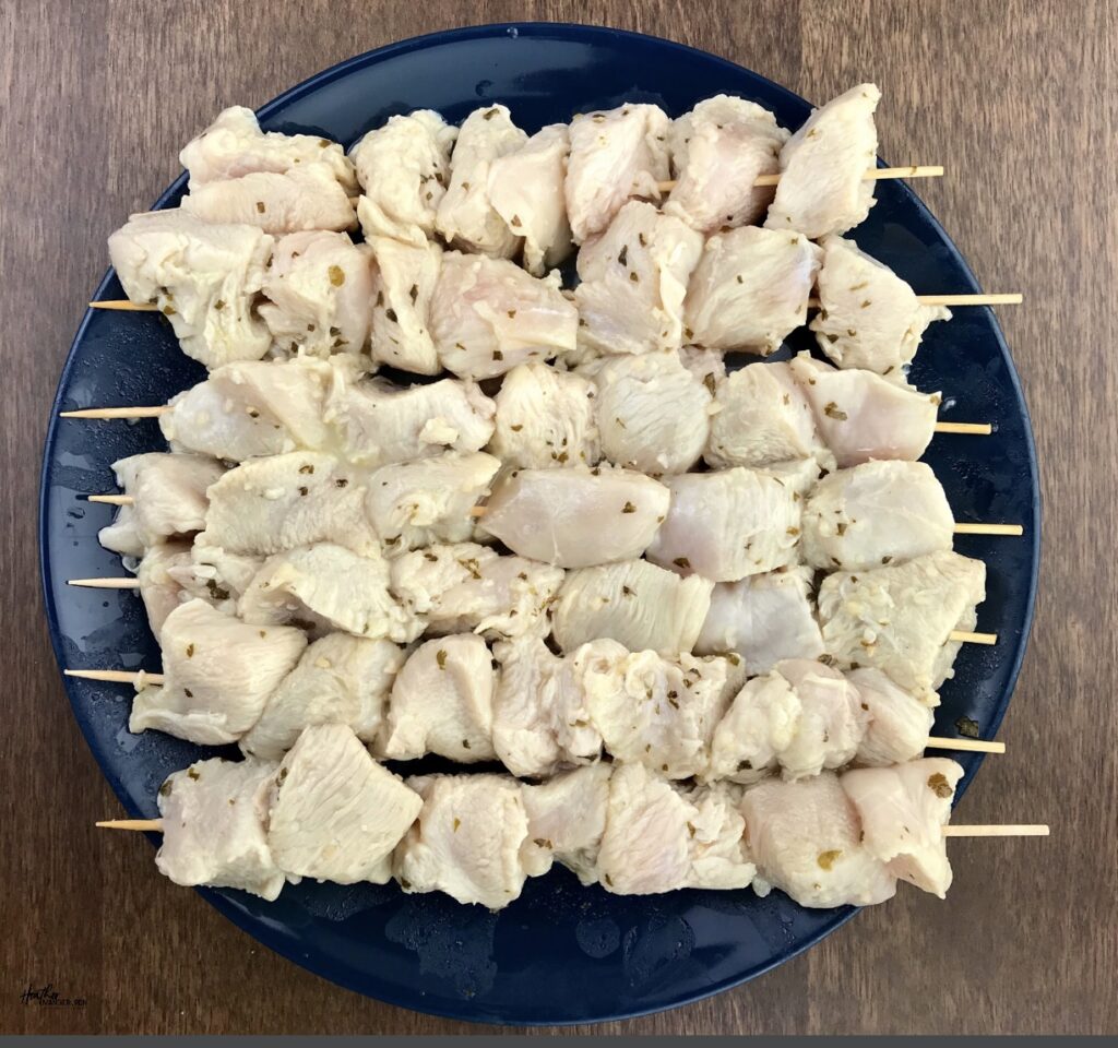 Raw boneless, skinless chicken breast cut and put on skwers to make kabobs