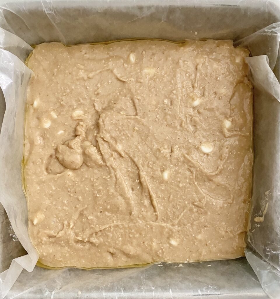 The step by step instructions to make white bean blondie bars - spreading in the pan