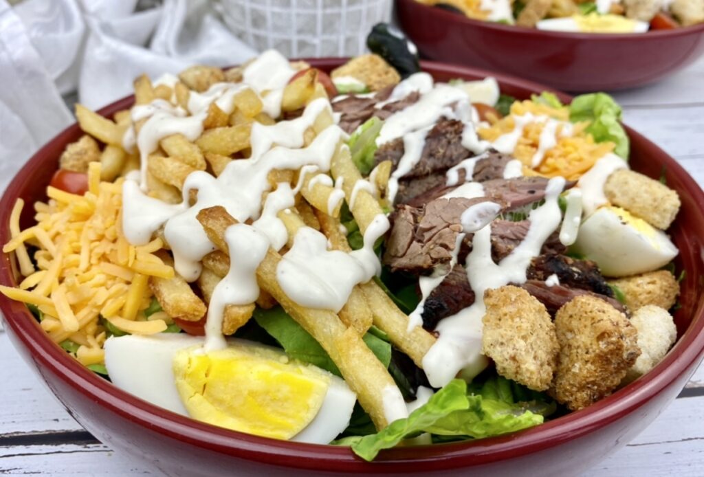 Enjoy a Pittsburgh original with this Pittsburgh steak salad – made with mixed green and topped with steak, French fried, egg & cheese & ranch dressing.